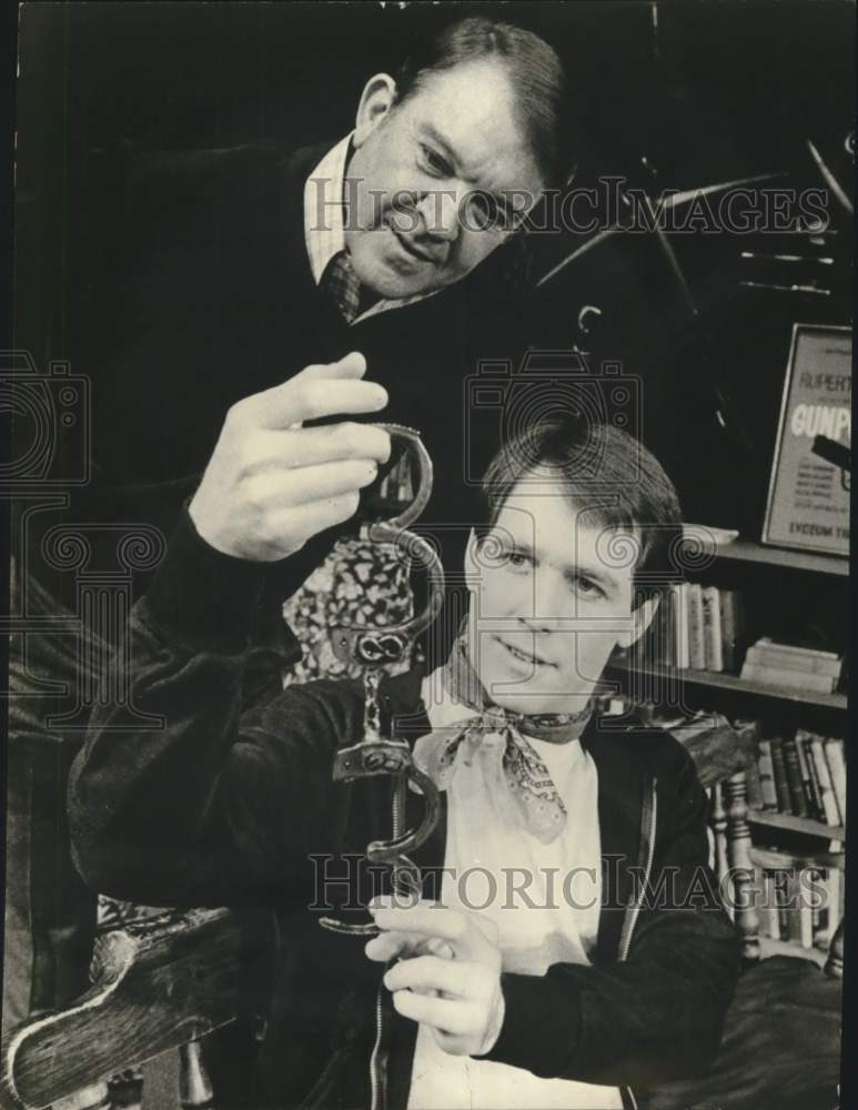 1980 Press Photo Donald Barton & Michael McBride examine handcuffs in New York - Historic Images