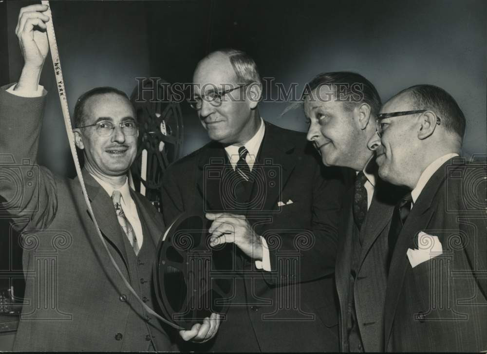 1952 Officials pose with reels from travel movie in New York-Historic Images