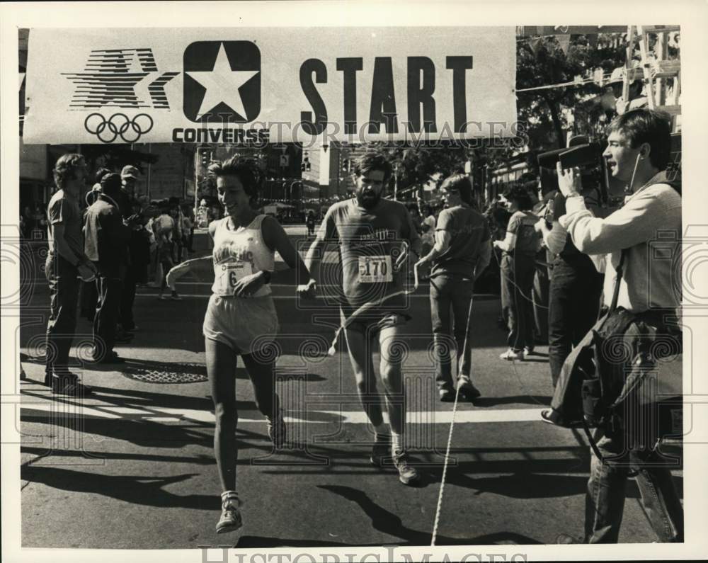 1984 Press Photo Runners cross finish line in Corning Cup Race in New York- Historic Images