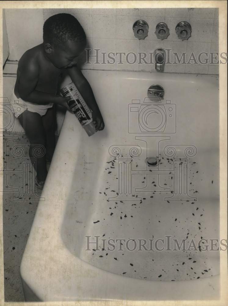1968 2-year old with can of raid and bathtub of bugs in Albany, NY-Historic Images