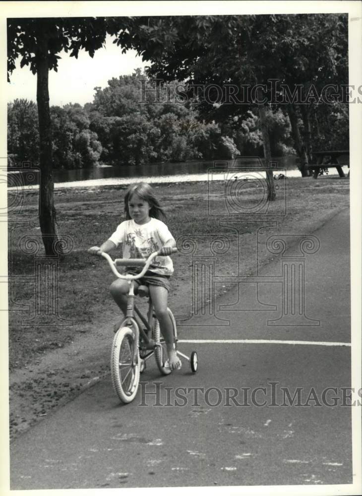 1990 Press Photo Jessica Miller rides on bicycle path in Albany, New York park- Historic Images