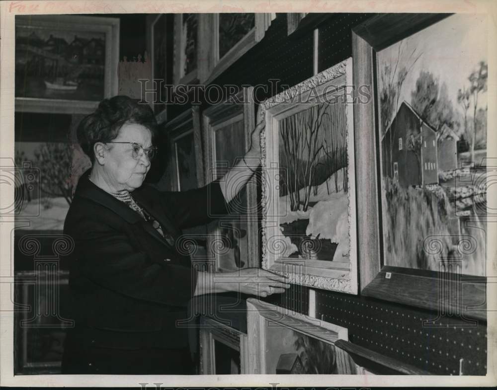 1965 Pauline Edson hangs art for exhibit in New York-Historic Images