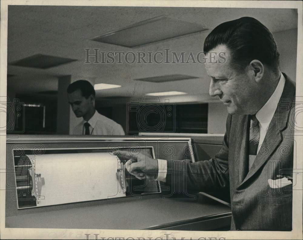 1968 Dr. Robert R.J. Gallati looks at printer-Historic Images