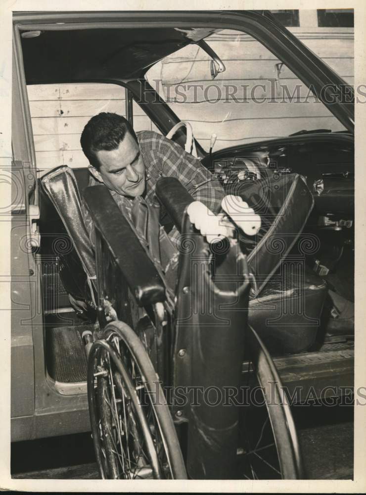 1961 Richard "Tex" Everton loads wheelchair into his car in New York-Historic Images