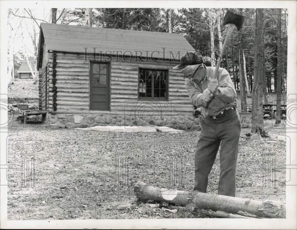 1962 Press Photo Howard Warrington Cuts Wood at Cabin - tub32613- Historic Images