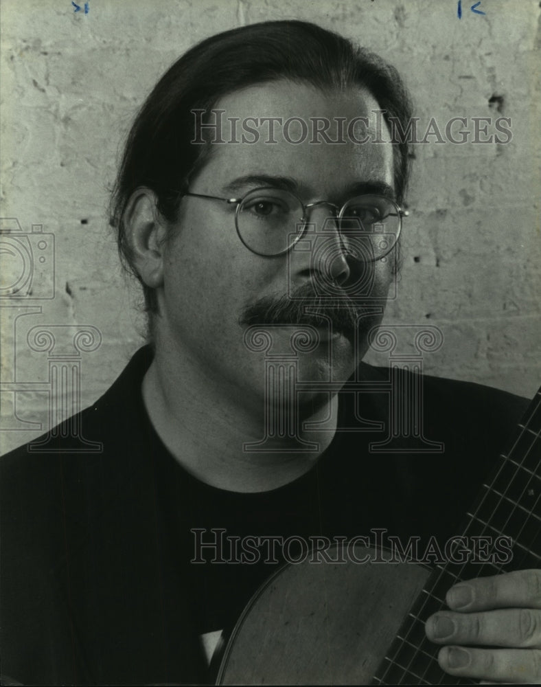 1996 Press Photo Musician poses for photo with his guitar - tup01403 - Historic Images
