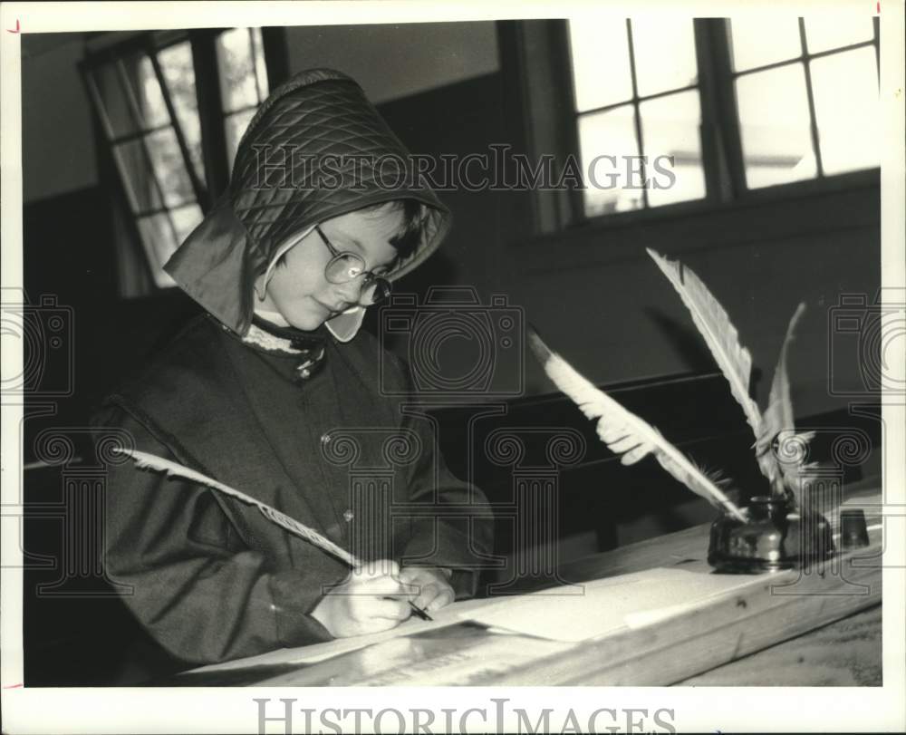 1994 Press Photo Girl signs paper at Hancock Shaker Village in Massachusetts- Historic Images