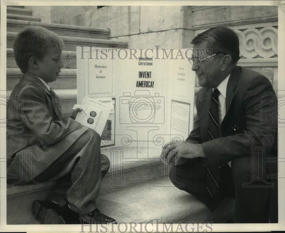 Press Photo Adam Sampson shows childproof outlet to Congressman Jerry Solomon - Historic Images