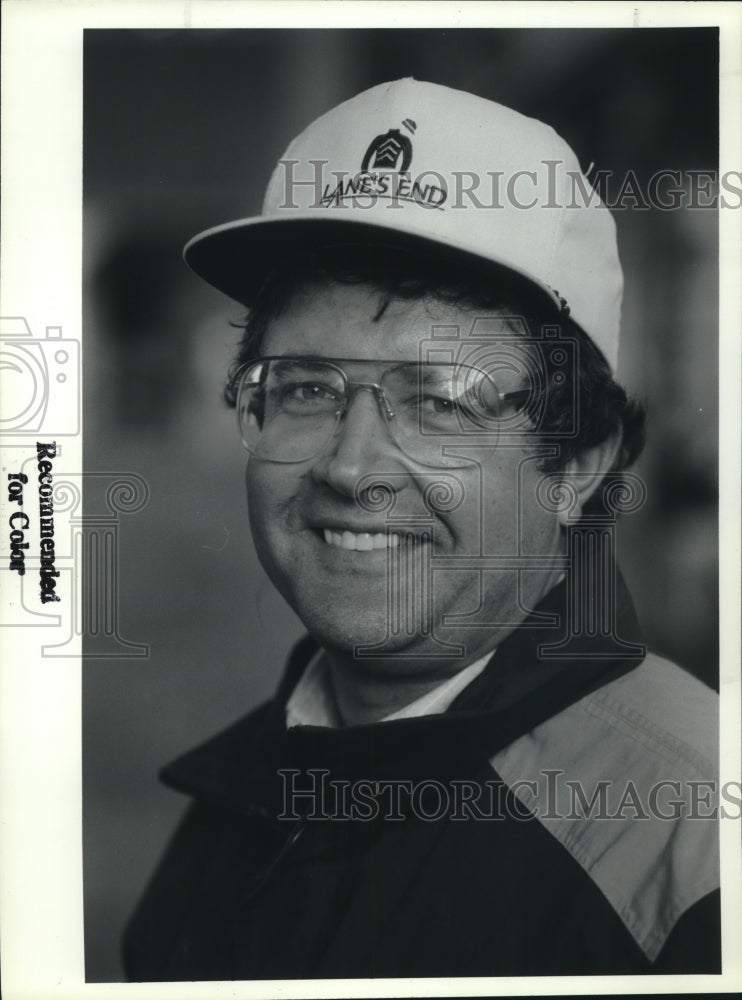 Dennis Brida smiles wearing a "Lane's End" hat - Historic Images