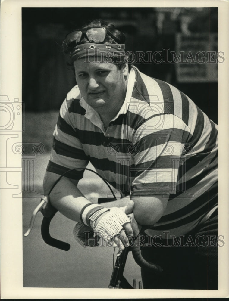 Press Photo Unidentified man rests on the handles of his bicycle. Spectator- Historic Images