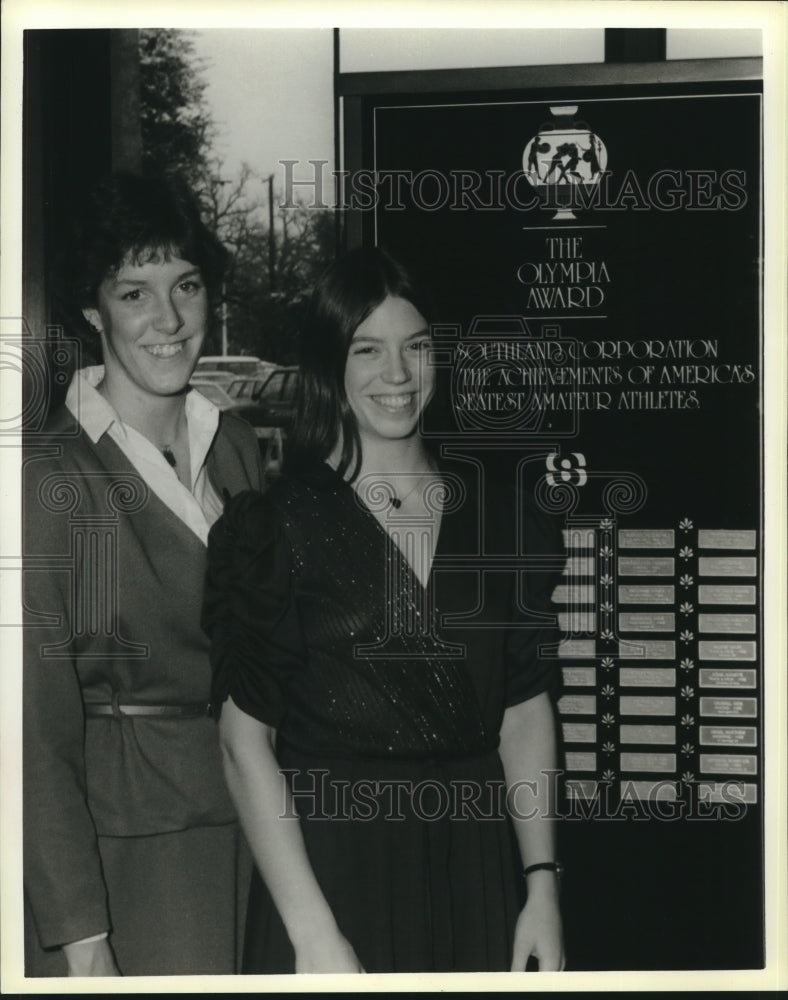 Press Photo Mary Lewis and another female stand in front of The Olympia Award- Historic Images