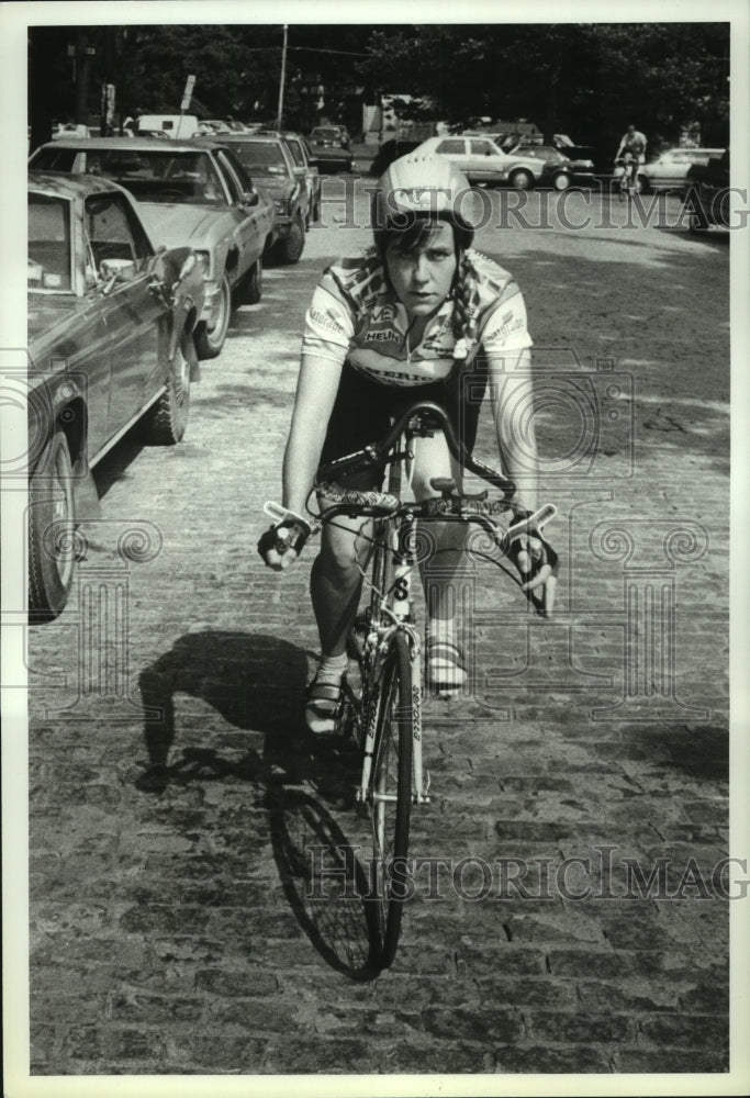 1990 Press Photo Marion Clignet poses on bicycle on Jay Street, Albany, New York - Historic Images