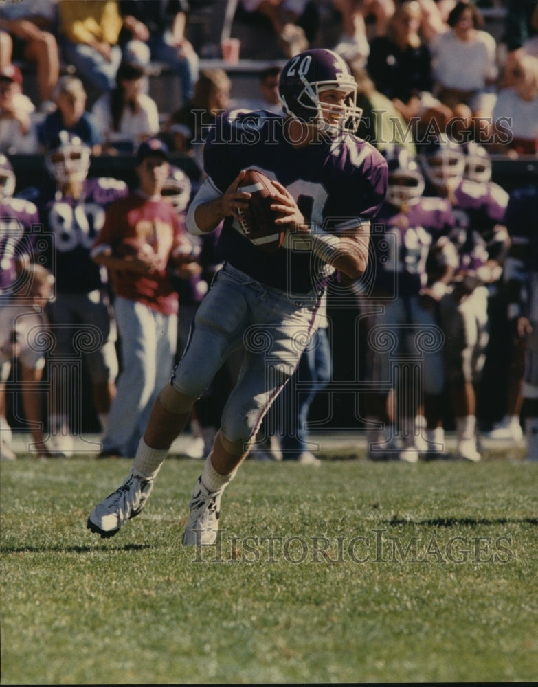 Football player #20 Tom Ciaccio gets ready to throw football - Historic Images