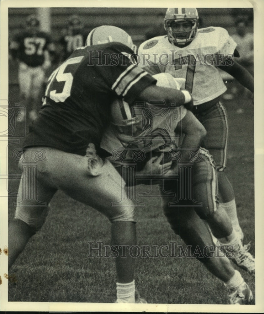 1987 Press Photo Mallers #33 is tackled by Hudson defender during first quarter - Historic Images