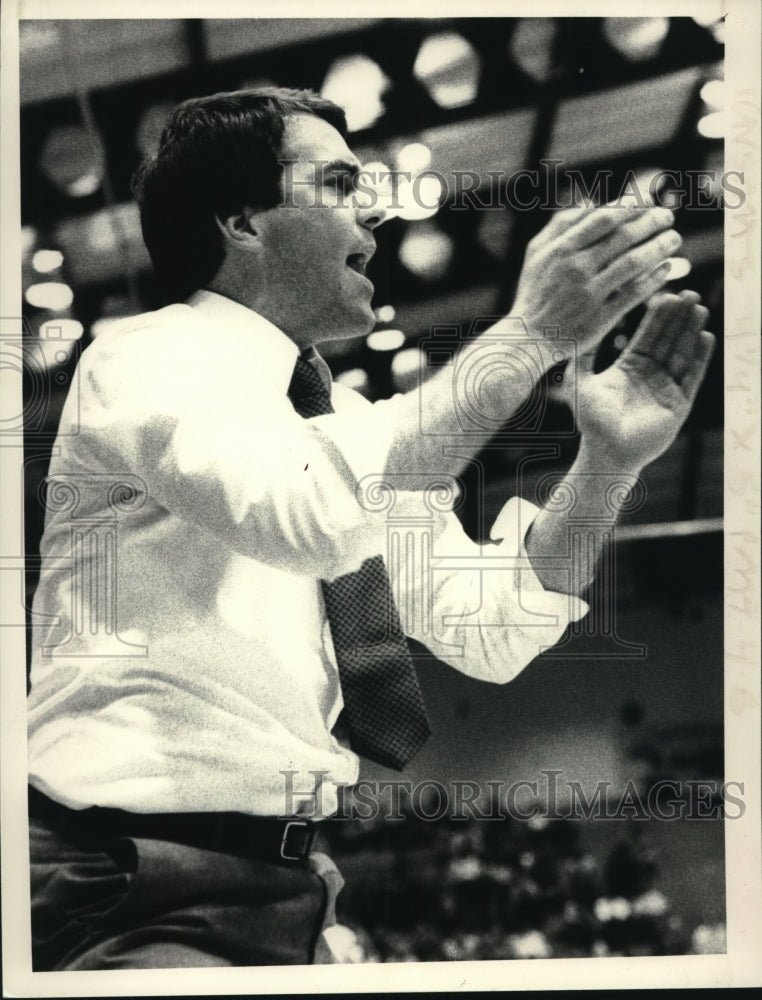  Basketball coach John Griffin claps his hands during game - Historic Images