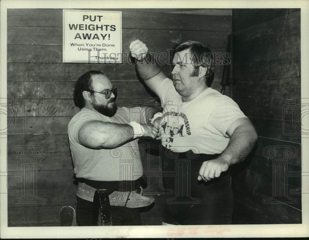 Press Photo Weightlifter Tomaski (right) gets assistance with his uniform - Historic Images